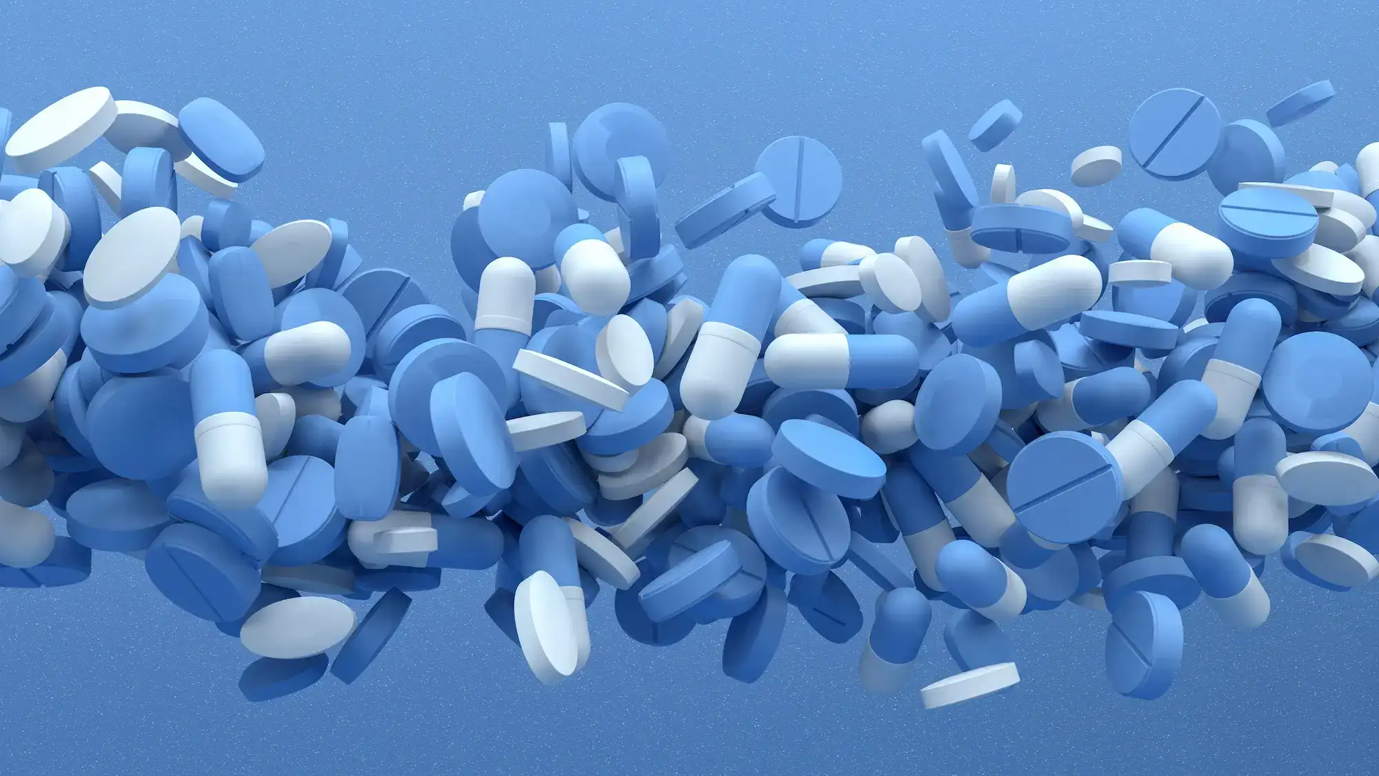 tabletten en capsules op blauwe achtergrond